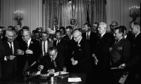 President Lyndon B. Johnson signs the Civil Rights Act into law