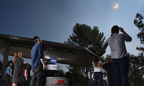 NASA employees and visitors watch the total solar eclipse from NASA’s Jet Propulsion Laboratory.